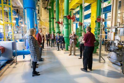 Several people listen to a tour leader give details on the building they're touring. 